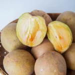 brown round fruits on a basket