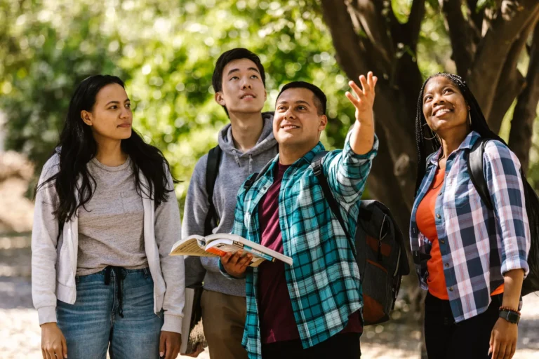 group of college student looking up on trees