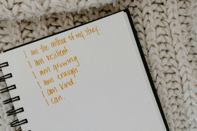 a notebook with encouraging quotes on a knitted fabric